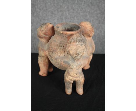 Terracotta 'rattle pot'. Tripod bowl supported by three figures. H.20cm. 