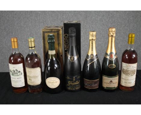 A mixed collection of seven bottles of red and sparkling wine. Includes a bottle of Lindauer Brut Champagne. 