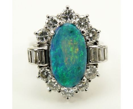 Oval Cabochon Black Opal, Approx. 2.0 Carat Diamond and Platinum Ring. Diamonds E-F color, VVS-VS clarity. Opal measures 13mm