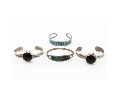 Grouping of Four (4) Sterling Silver Bracelets. Includes: two sterling and onyx inlaid cuff bracelets, Sterling turquoise and