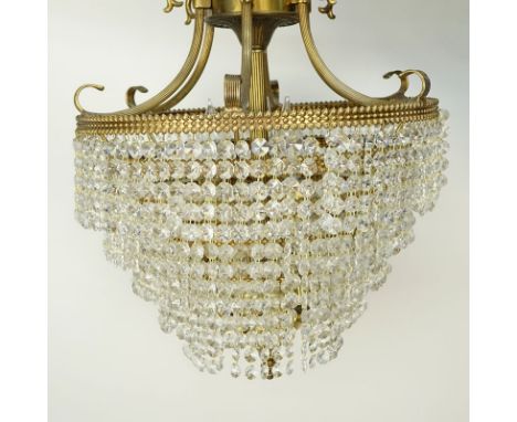Vintage Brass and Crystal Wedding Cake Style Chandelier. Decorated with  six arms and five tier hanging crystals. Some rubbin