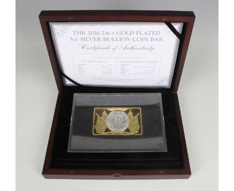 A Westminster Collection five-ounce silver gilt and silver bullion coin-bar, detailed with a Silver Eagle dollar 1986, slabbe