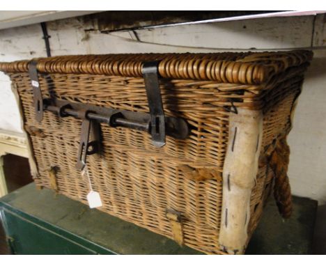 A Vintage wicker hamper with sliding steel lock and carrying handles.