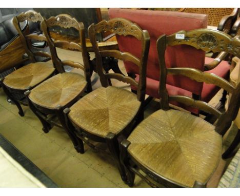 A set of 4 French oak ladder back rush seated dining chairs.