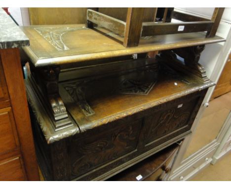 A 1920s carved and panelled oak monk's bench.