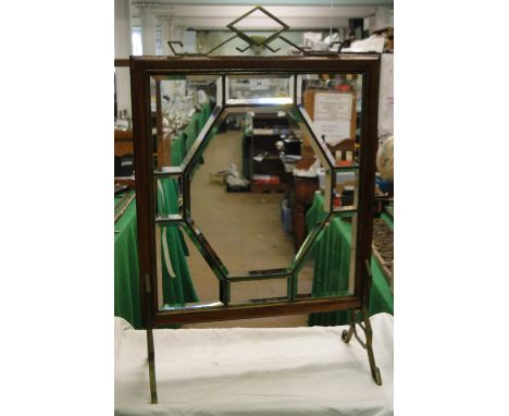 A mahogany framed firescreen with bevelled mirrored panels, Arts & Crafts brass mounts.