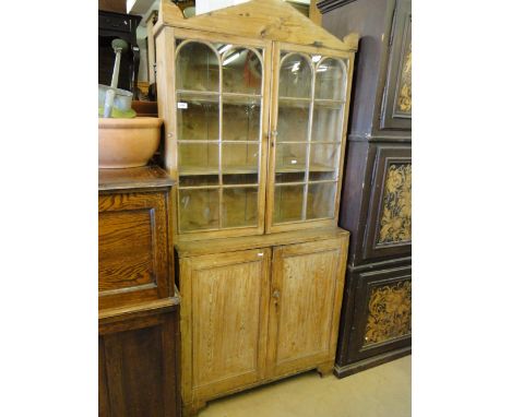 A continental all-in-one polished pine dresser with glazed cupboards to the top, bracket feet.