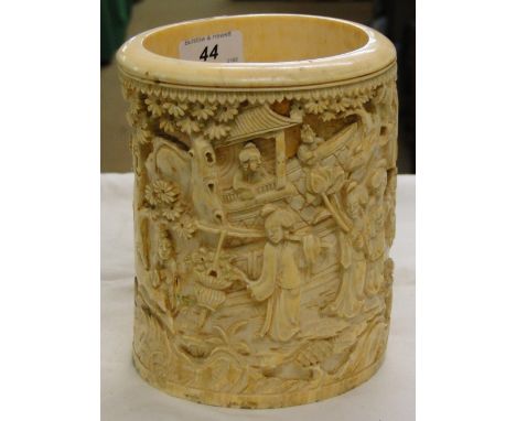 A piece of Oriental carved ivory depicting figures and trees.