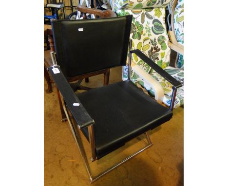 A Mark Singer Euroka folding rocking chair for Melamede in black leather a chrome, makers label under seat cushion, (held by 