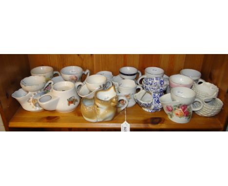 A shelf of Vintage porcelain shaving mugs.