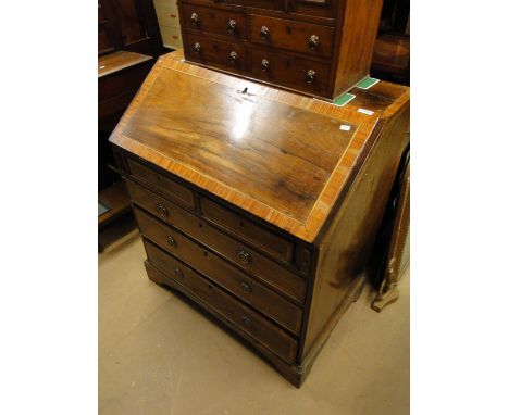 A Georgian crossbanded rosewood bureau, with fitted interior and 5-drawers under on bracket feet.