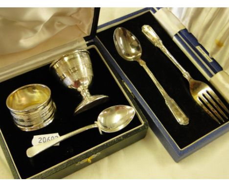 Cased silver fork and spoon, cased silver eggcup, spoon and napkin ring.