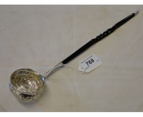 An embossed silver and walrus handled toddy ladle.