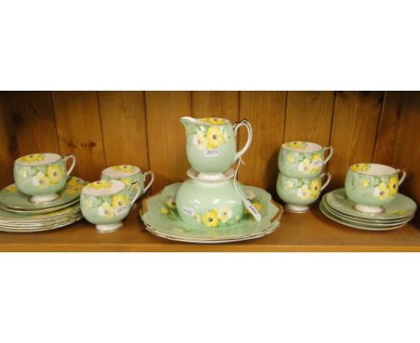 A 1930s Shelley porcelain tea service for 6 people, pattern no. 12635 with green ground and yellow and white floral decoratio