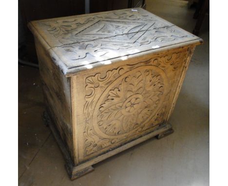 A carved oak box on bracket feet.