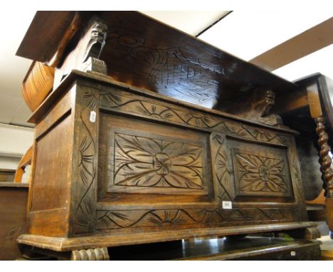 A carved and panelled oak monk's bench, and an oak 3-train mantel clock.