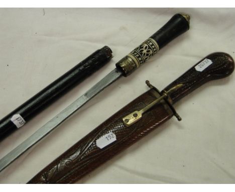 Indian dagger in scabbard and an ebony walking cane.