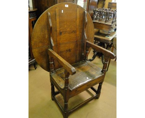 An Antique oak monk's single seat bench, with circular top.