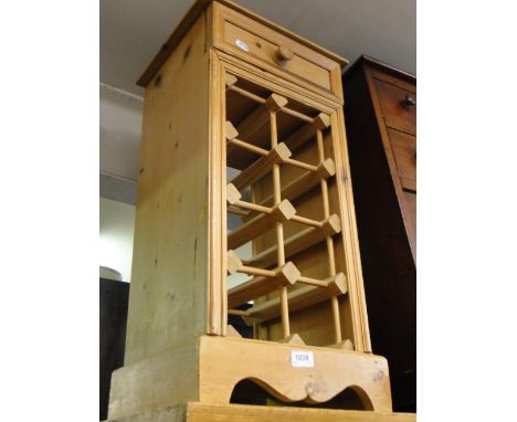 A modern pine narrow wine rack with drawer.