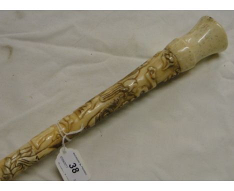 An Oriental carved bone walking stick.