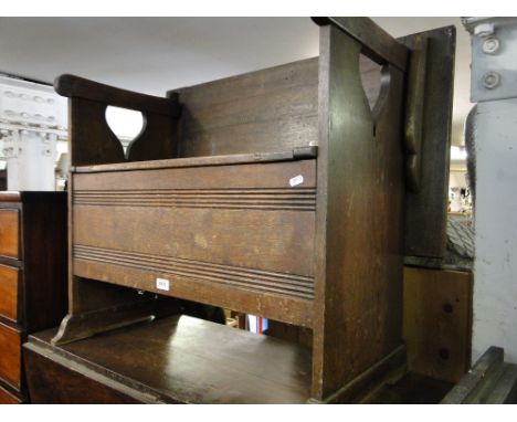 A carved oak Monk's bench.