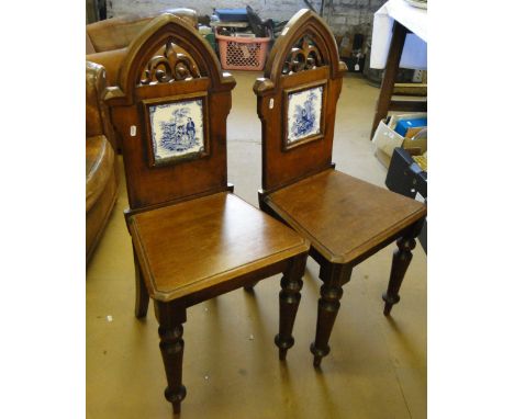 Pair of Victorian Gothic stained pine side chairs, with arched tops and inset tile panelled backs.