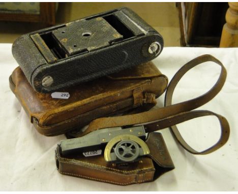 A Kodak folding camera and a small Stanley instrument, both leather cased.