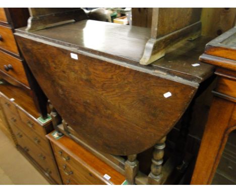 A large Antique oak gateleg table on bobbin turned legs.