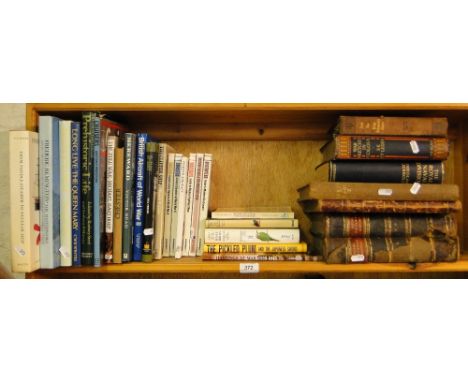 A shelf of leather bound and Reference books.