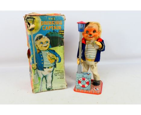 S & E - Amico Imports - A boxed Battery Operated Drinking Captain (4101) Item shows some signs of use and age; 1 eye has a sc