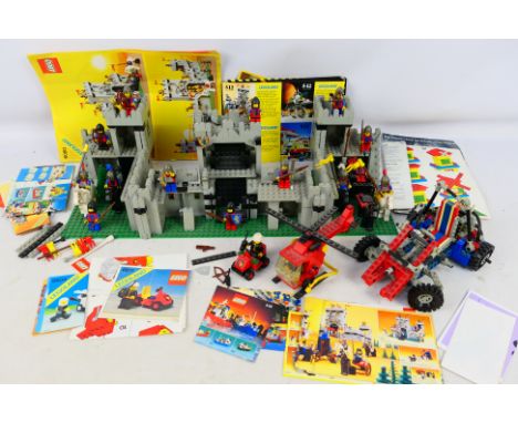 Lego - A mixed assortment of various unboxed vintage Legoland and Technic pieces, figures and instructions appearing to relat