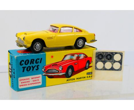 Corgi Toys - A boxed Corgi Toys # 218 Aston Martin DB4. The model in primrose yellow with boidy vent, red interior flat spun 