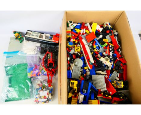 Lego - A large mixed assortment of loose Lego pieces. Includes bases, mini figures and some assembled and part-assembled item