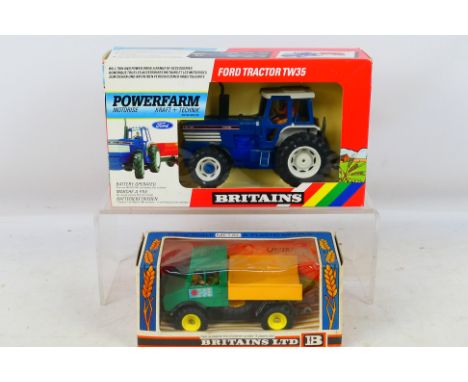 Britains - A pair of farm related diecast vehicles. Includes #9321 Battery Operated Ford TW35 Tractor in excellent-near mint 