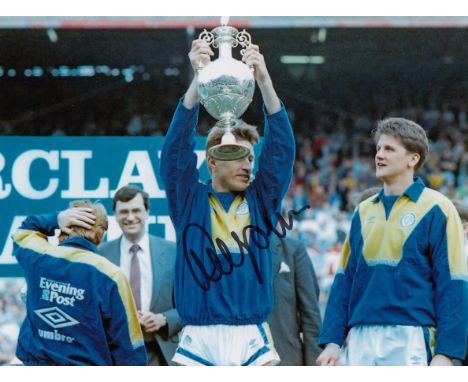 Football Autographed LEE CHAPMAN photo, a superb image depicting the Leeds United centre-forward holding aloft the First Divi