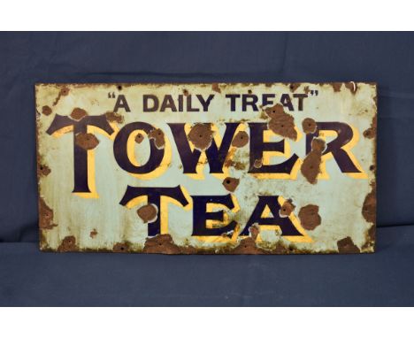A vintage Tower Tea enamel sign - advertising interest TOWER TEA "A DAILY TREAT", 12 X 24in. (30.5 x 61cm.), showing rust, fa