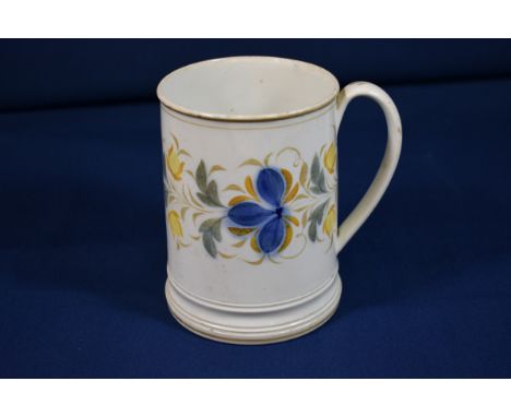 A large late 18th century Creamware tankard with floral ring decoration in blues and yellows, 5¬in. (13.3cm.) high. 