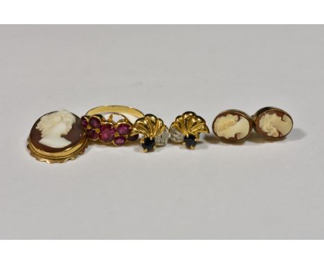 A yellow gold and ruby or garnet ring with central oval cut and six round cut stones, ring size I, together with a pair of sh