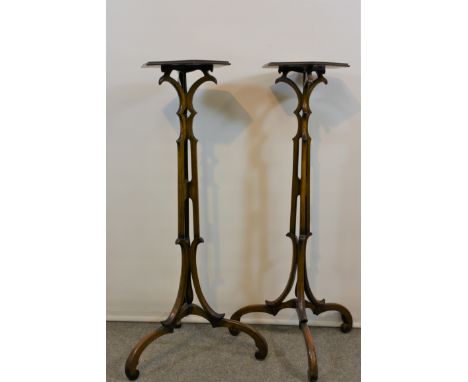  A pair of 19th century mahogany candle stands of torcheres in the Chippendale Gothic style  the hexagonal tops raised on pie