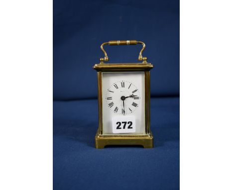 A French gilt brass carriage clock in Corniche case, white enamel Roman dial, signed 'Maine Jersey' (rubbed), single train mo