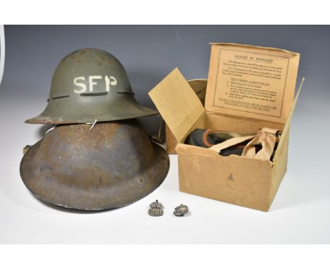 A WWII British Zuckerman helmet with SFP (Street Fire Party) letter, a British steel helmet, 2 civillian respirators in origi