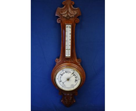 A Victorian carved walnut barometer. 