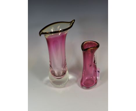 Two ruby red moulded art glass vases the tallest 16in. (40.7cm.) high, indistinct signatures Hlyn? (2) 