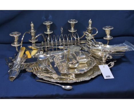 A collection of silver plate including a pair of twin arm candelabra; circular twin handled tray with fruiting vine border; a