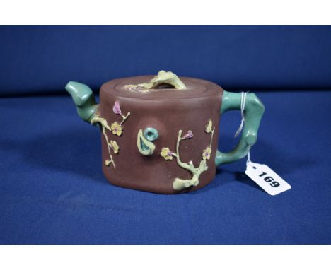 A Chinese Yixing teapot and cover probably early 20th century, enamelled tree trunk spout and handle, prunus branch finial, 3