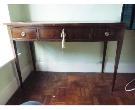 A bow front three drawer console table, approximately 81 cm x 122 cm x 57 cm.

NOTE: ITEM IS LOCATED IN THE CW6 POSTCODE AREA