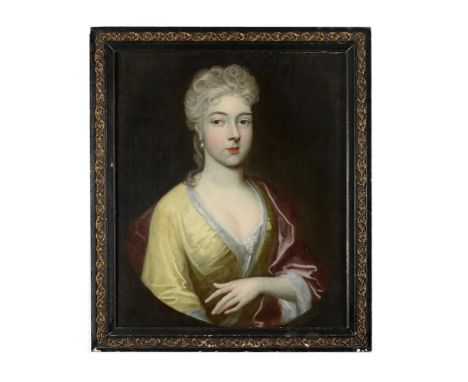 ENGLISH SCHOOL (EARLY 18TH CENTURY)PORTRAIT OF A LADY, WEARING A YELLOW SILK DRESS, IN A PAINTED OVALOil on canvas73 x 60cm (