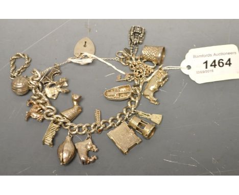 A silver curb link charm bracelet, a selection of silver charms, 108g approx