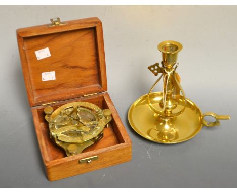 A ship's brass candlestick; a reproduction brass marine compass, boxed (2)