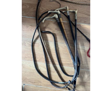 Four hunting crops; one Swaine &amp; Adeney, one Brigg, all with silver collars